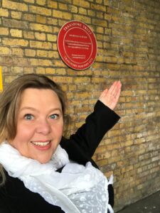 Hazel in front of Spa Road Station Plaque