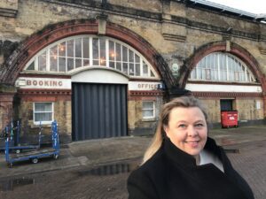 Hazel in front of Spa Road Station Booking Office