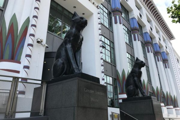 Photo of the cat statues outside the old Black Cat Factory by maggie coates